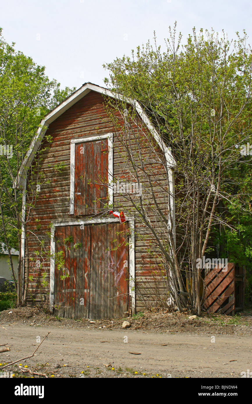 Old barn in a wooded spot Stock Photo