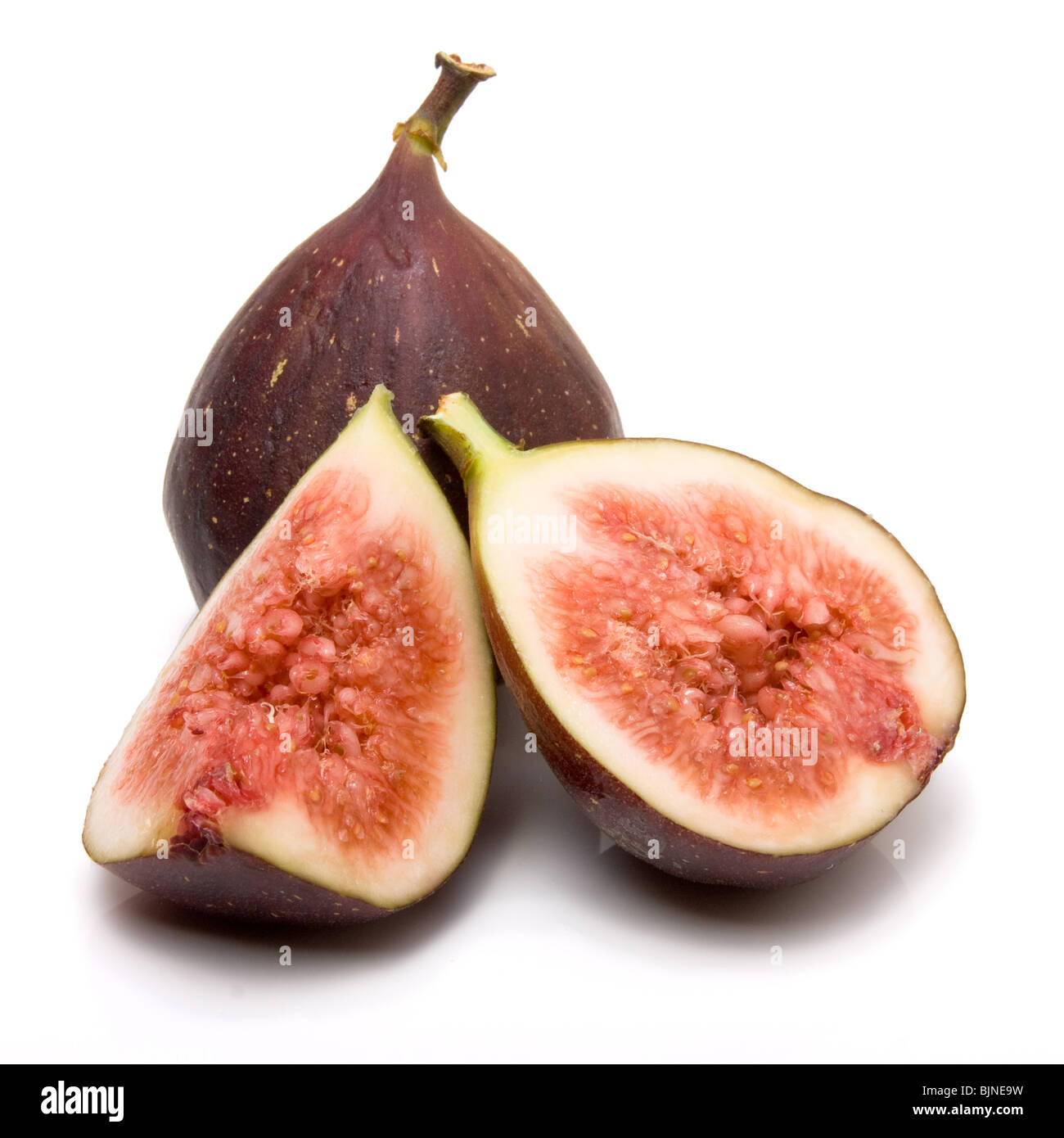 Sliced ripe figs from low viewpoint isolated against white background. Stock Photo