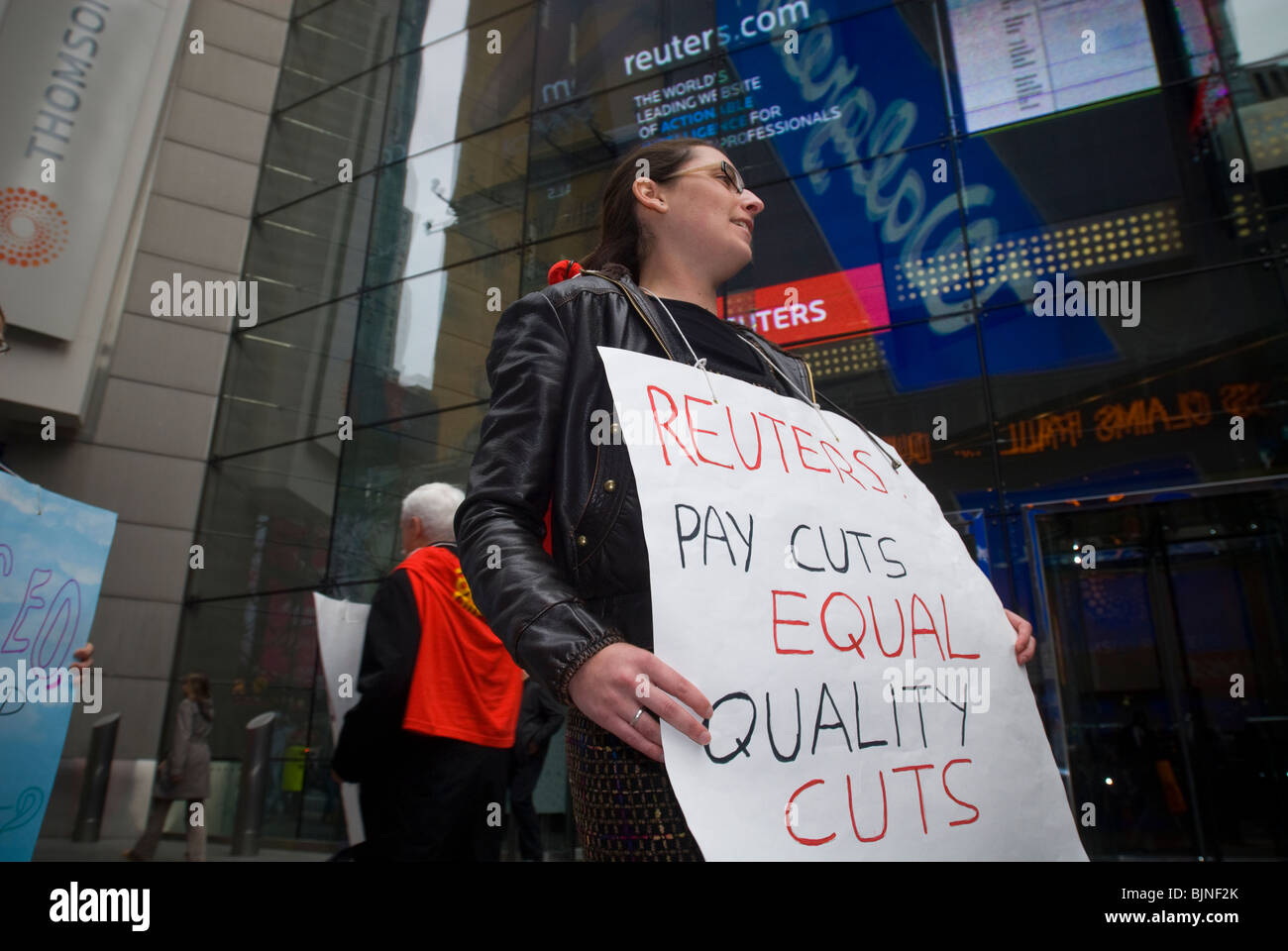 Members of the Newspaper guild of New York protest outside of the New York headquarters of Thomson Reuters in Times Square Stock Photo