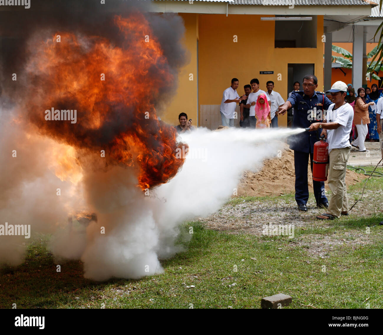 Fireman showing how to use the fire extinguisher properly in Malaysia