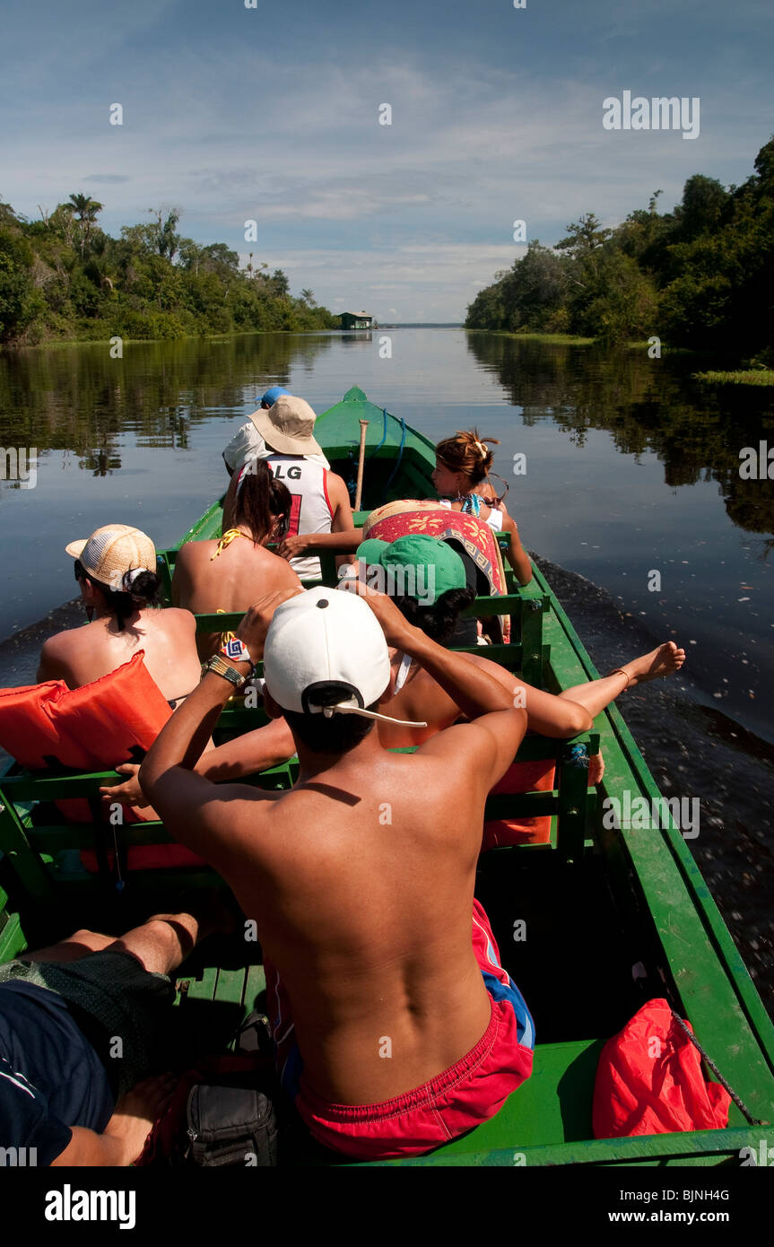 Ecotourism in Amazon rain forest. Tourists in a boat ride at Rio Ariaú ( Ariaú river ) Amazonas State, Brazil. Stock Photo