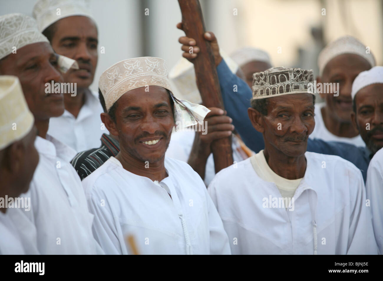 Men celebrating Maulidi outside Riyadha Mosque Lamu Kenya Stock Photo