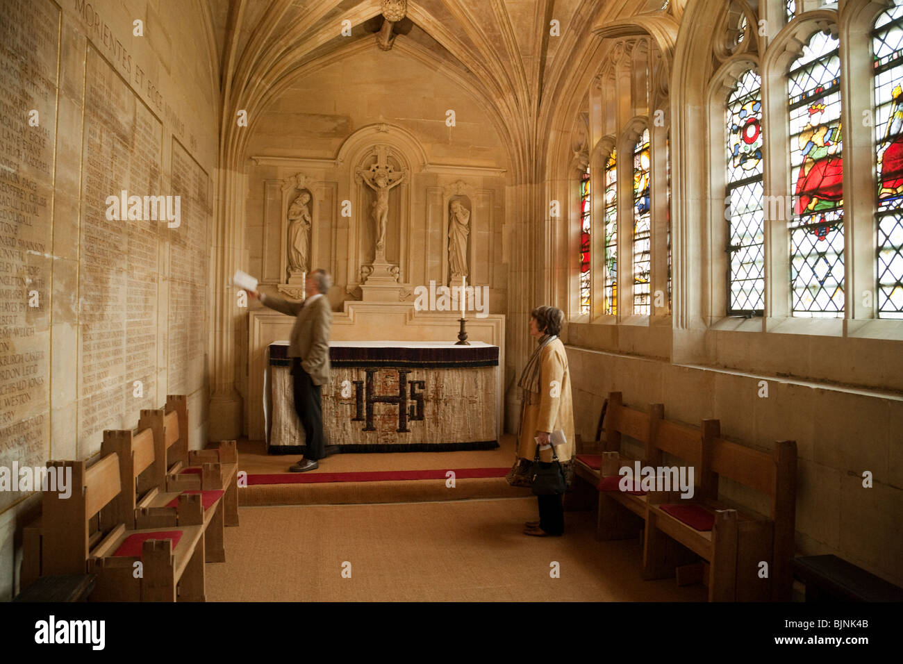 Tourists looking at the names of the dead in World War 1, the Chapel, Kings College Chapel, Cambridge UK Stock Photo