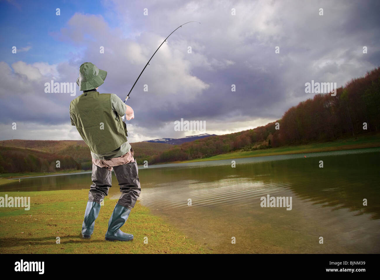 A young euphoric fisherman at Mavrovo lake Stock Photo