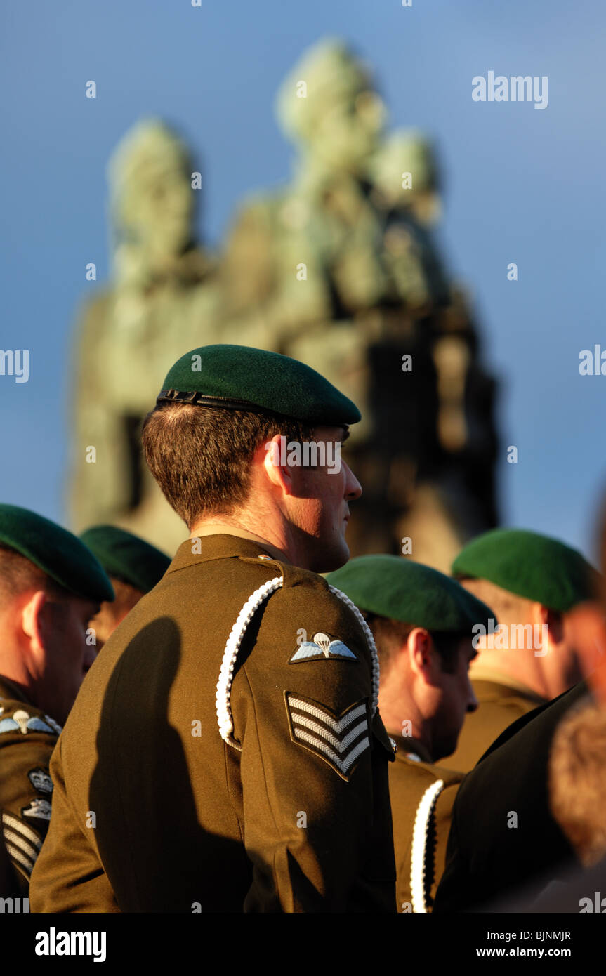Soldier's seen from the rear during remembrance day celebrations with the commando memorial spean bridge in the background Stock Photo