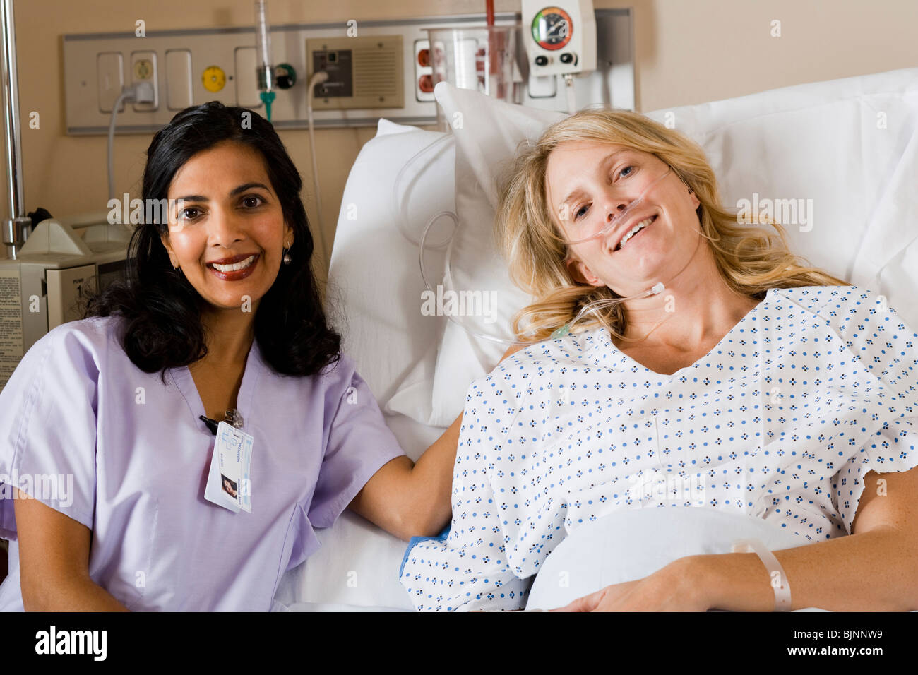 Woman in hospital bed smiling Stock Photo