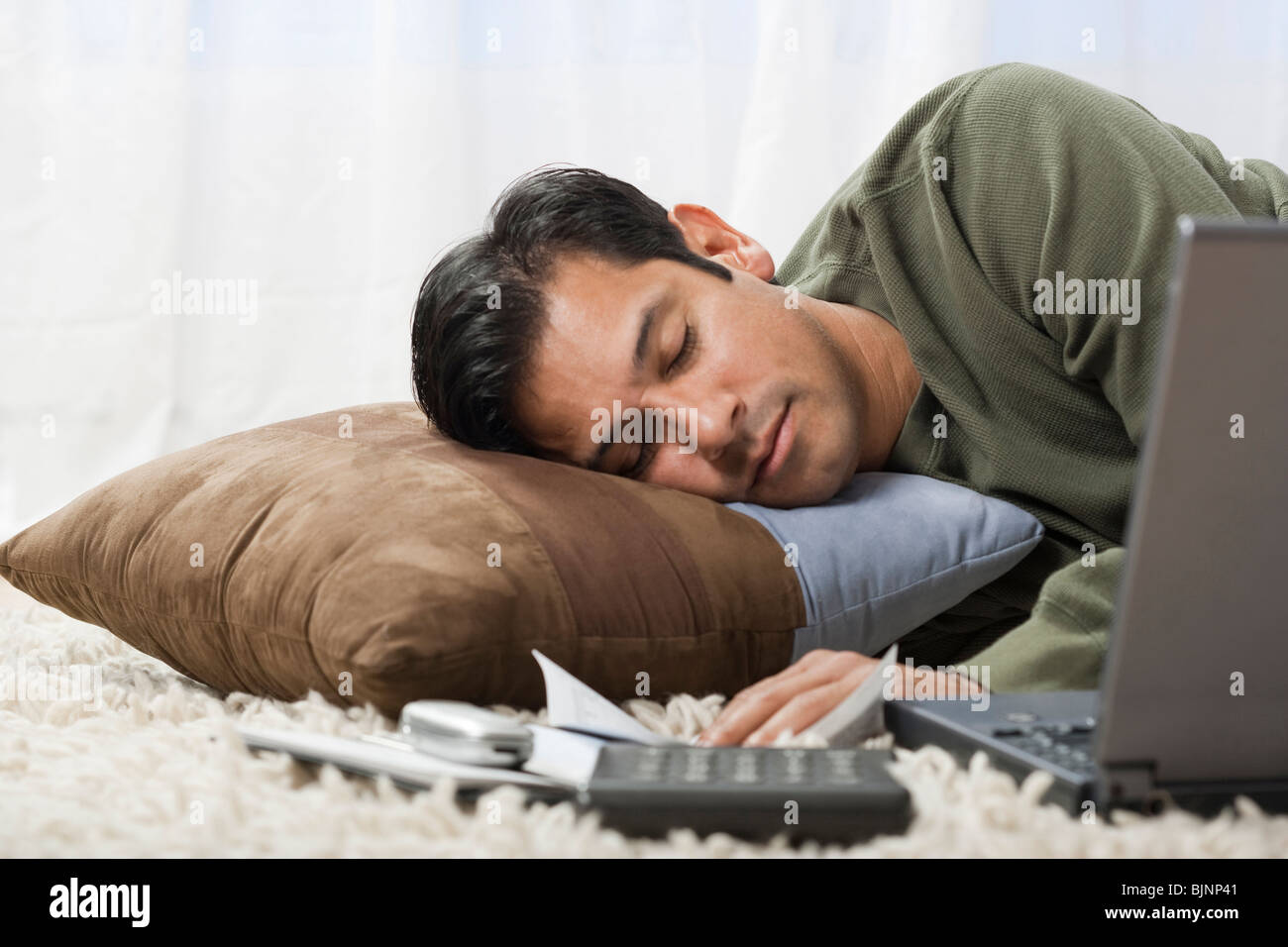 Man sleeping on cushion Stock Photo