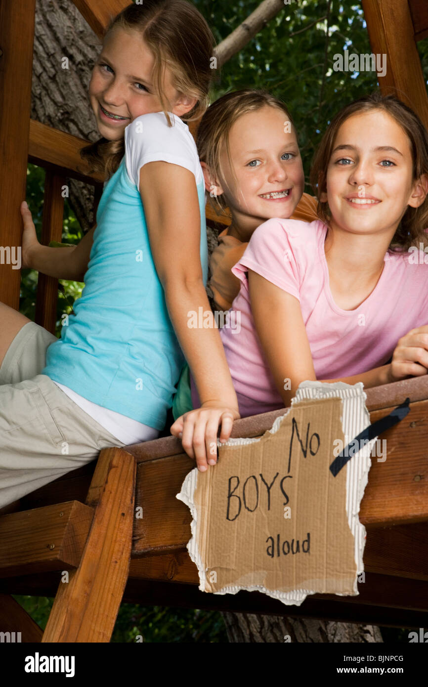 Girlfriends in a tree house Stock Photo
