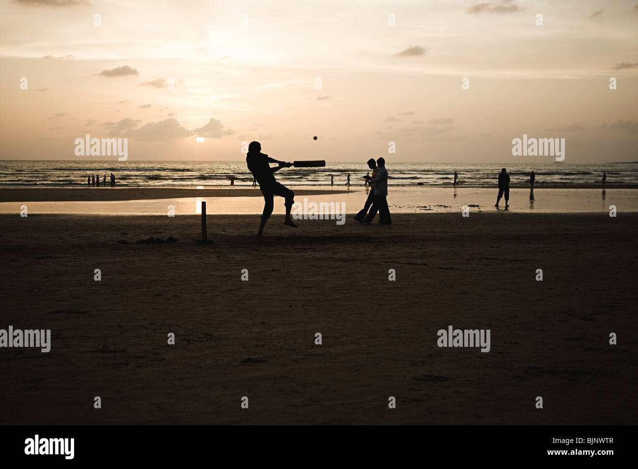 People playing cricket on mumbai beach Stock Photo
