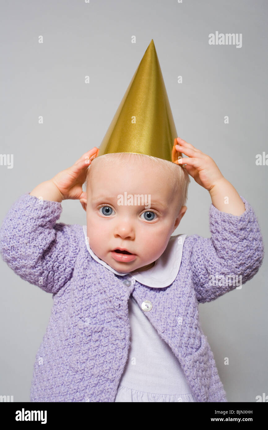 Baby with a party hat Stock Photo Alamy