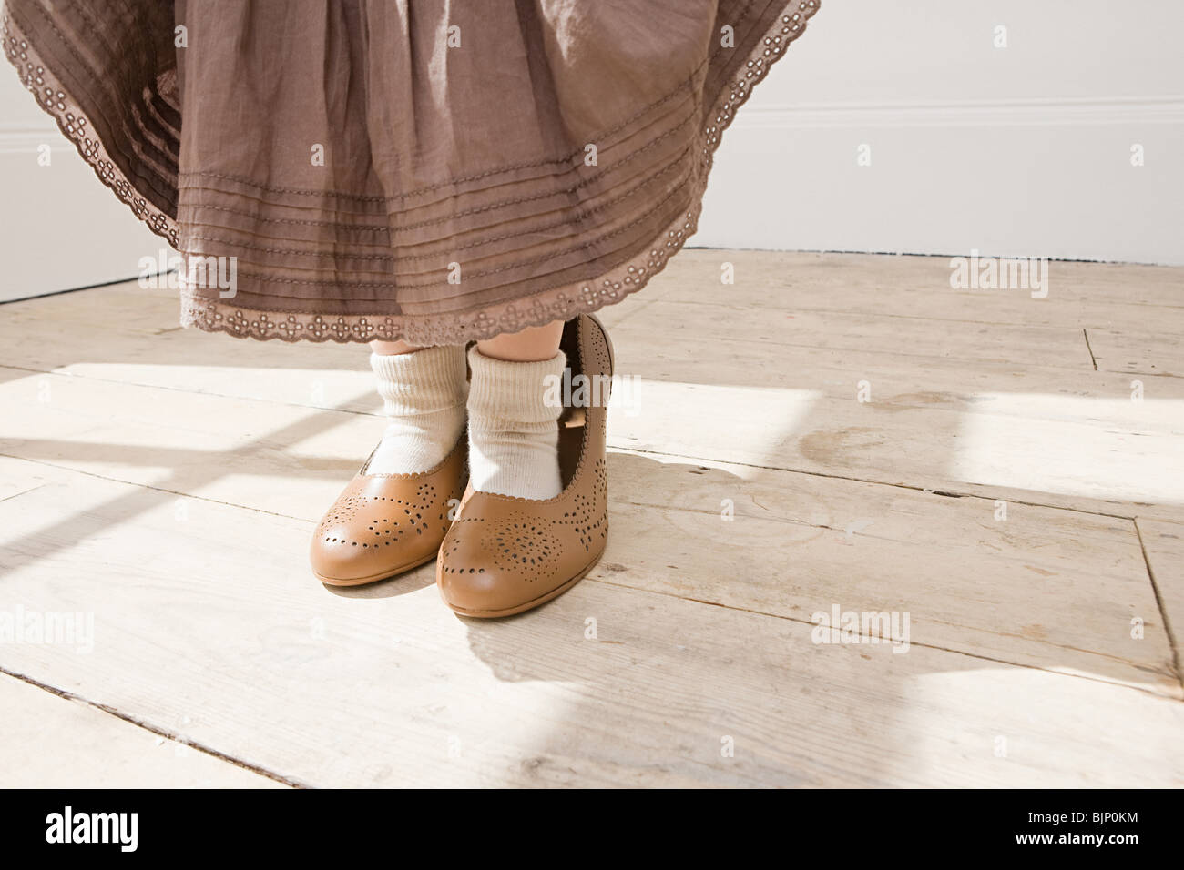 Young girl wearing high heel shoes hires stock photography and images