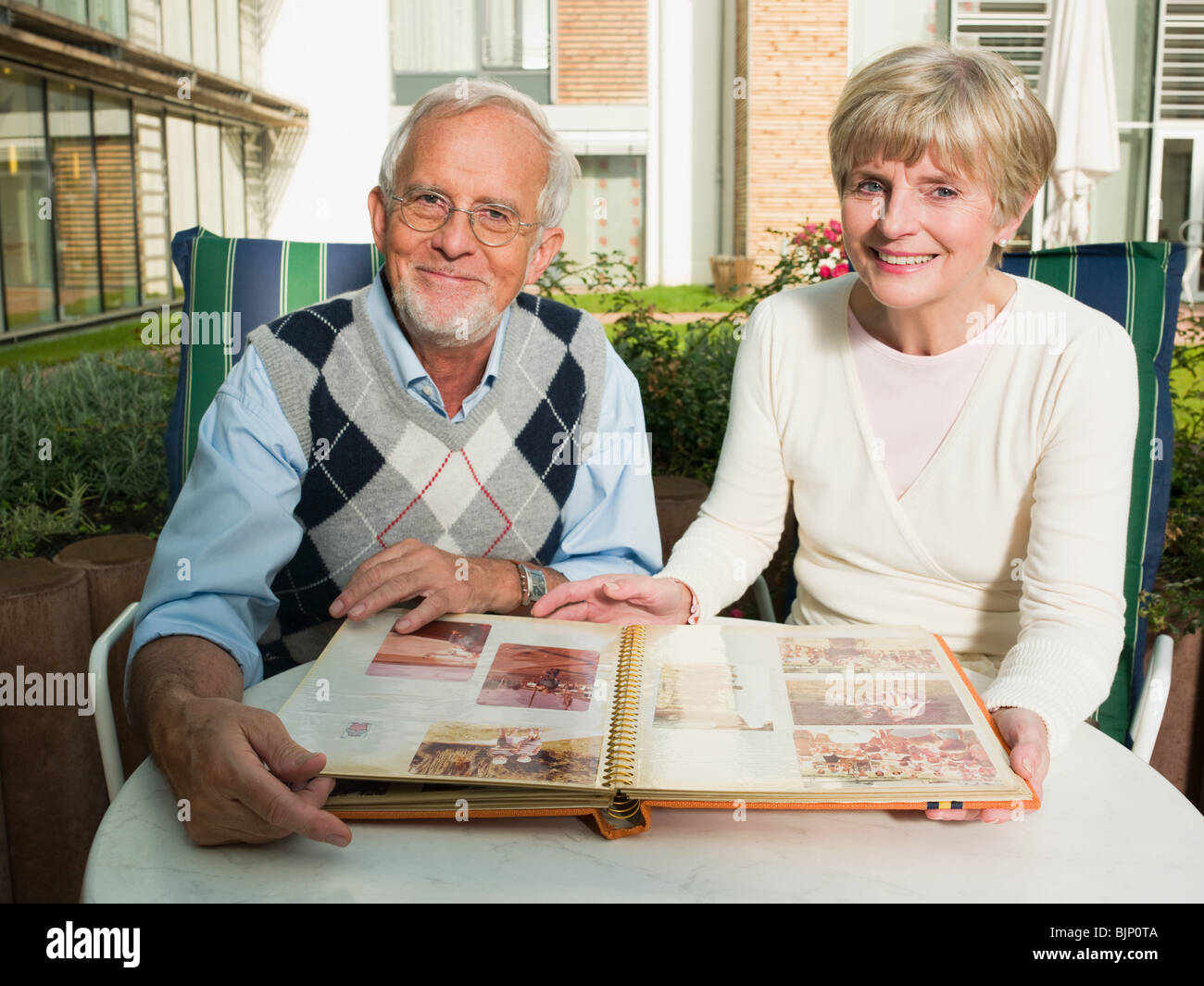 Senior couple looking at a photo album Stock Photo - Alamy