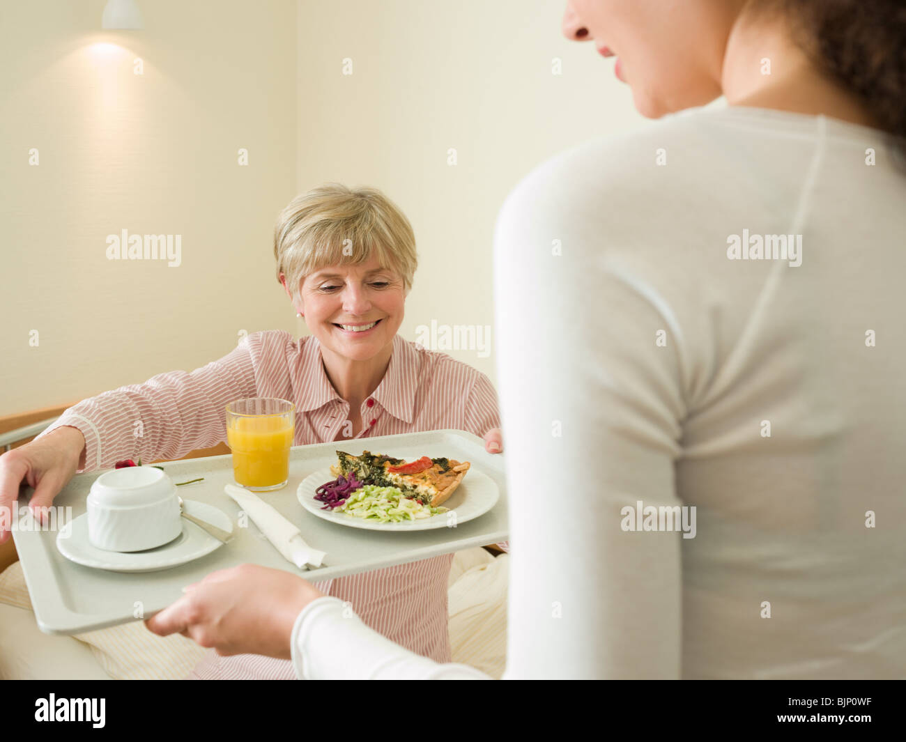 Woman getting lunch served in bed Stock Photo Alamy