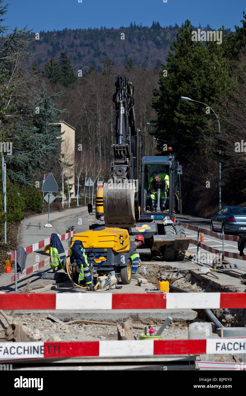 Construction workers working on pipes in the road. Neuchatel, Switzerland. Charles Lupica Stock Photo