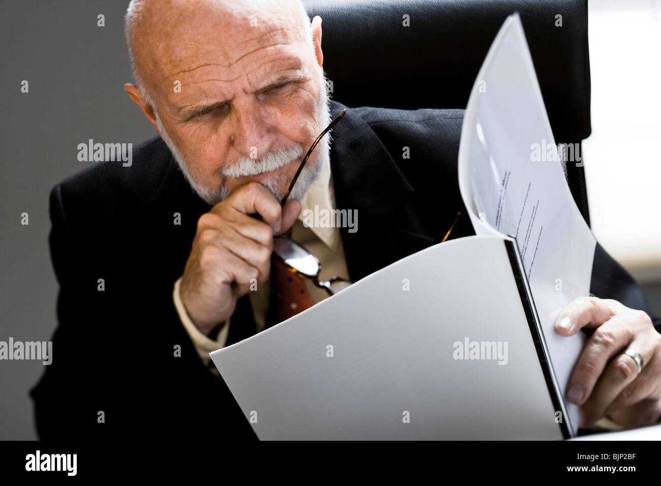 Closeup of businessman reading report Stock Photo