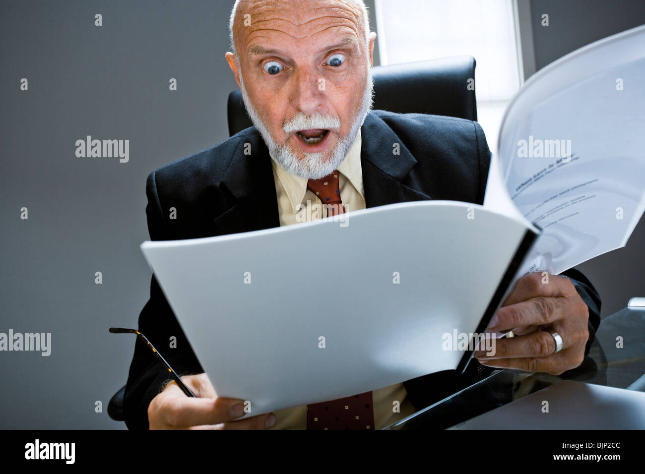 Closeup of businessman reading report Stock Photo