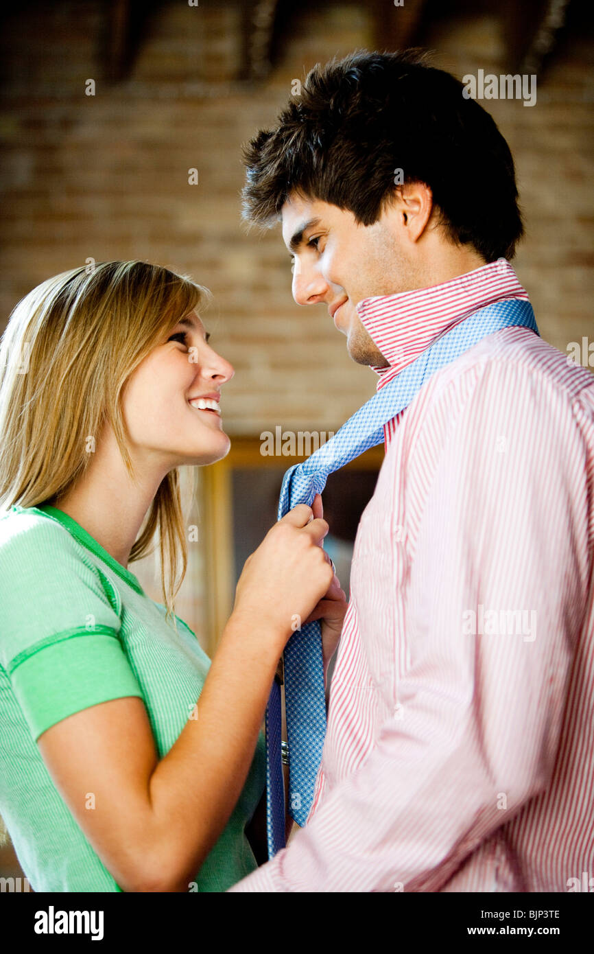 Girlfriend holding boyfriend's necktie Stock Photo Alamy