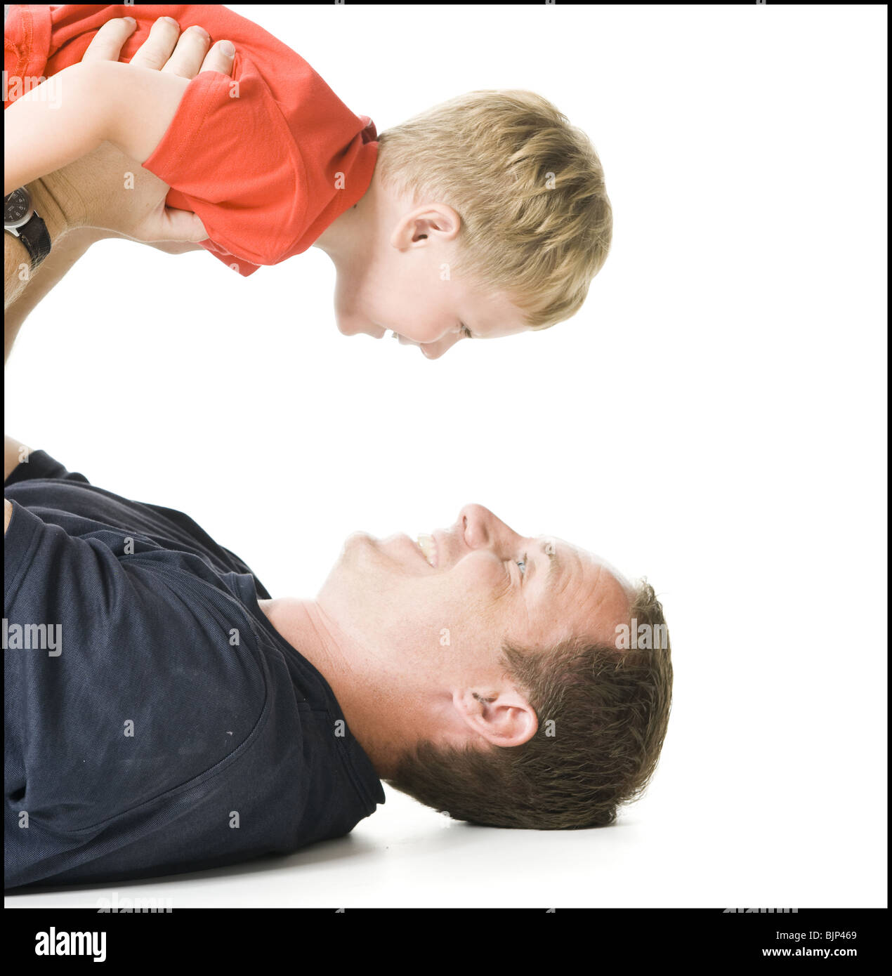 Parents holding kids upside down hires stock photography and images
