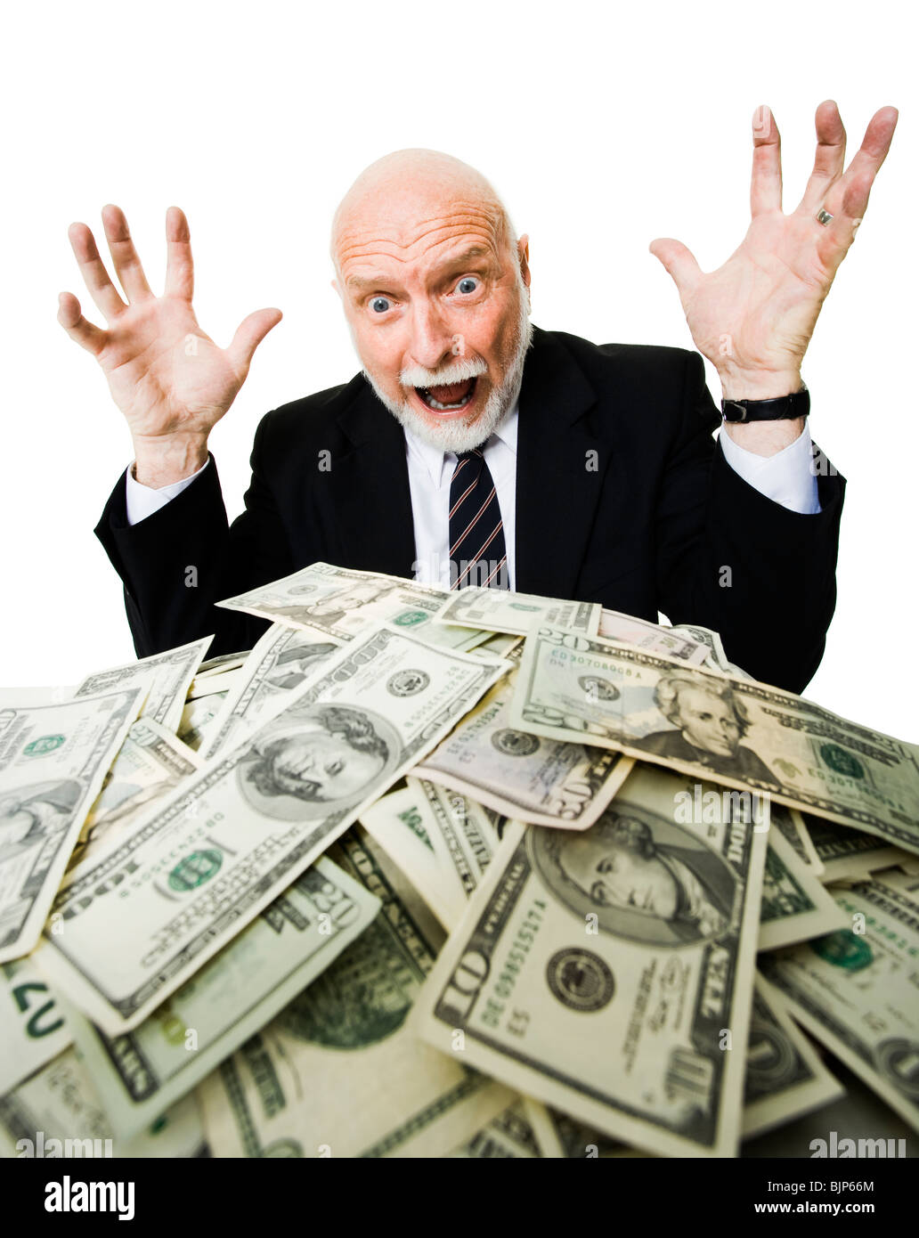Closeup of businessman looking at pile of money Stock Photo