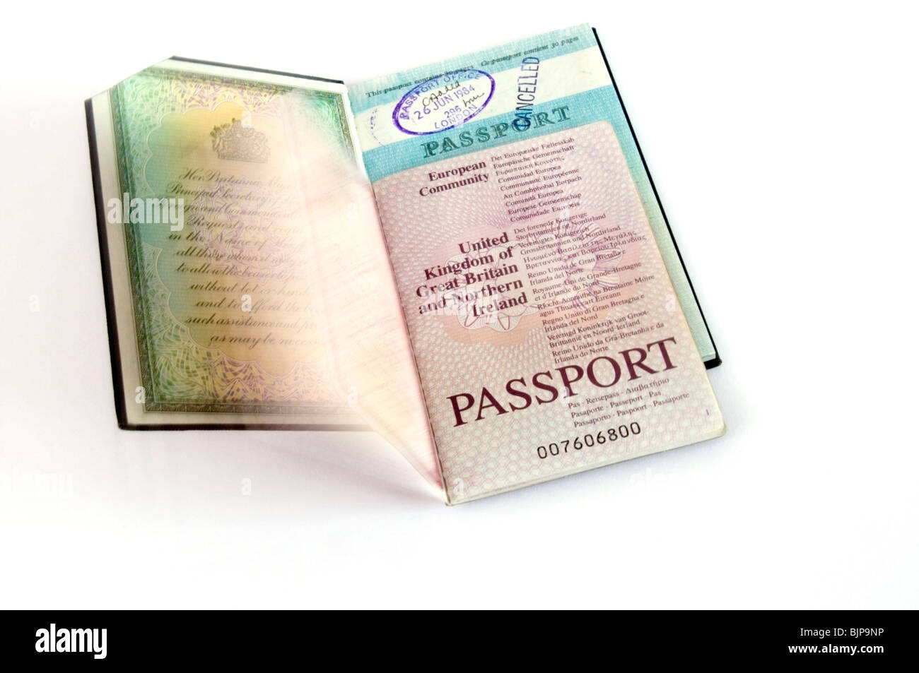 Open old, cancelled and new European Community, British  travel passports on white background, cut-out, United Kingdom Stock Photo