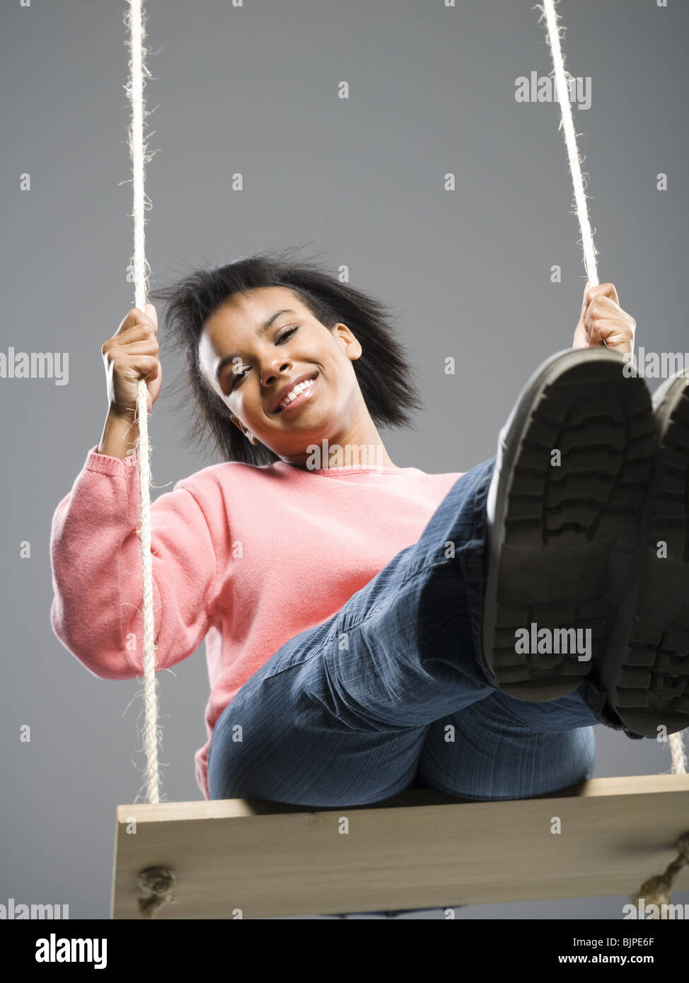 Young woman on a swing Stock Photo - Alamy