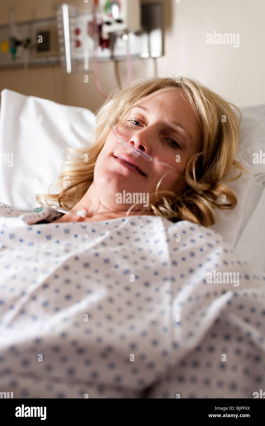 Woman sleeping in hospital bed Stock Photo