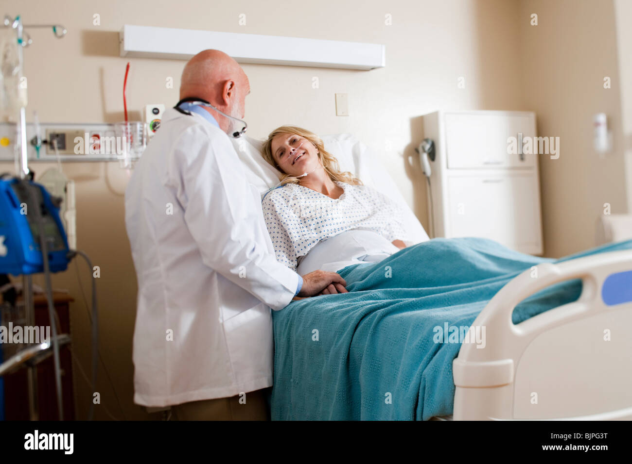 Woman in hospital bed Stock Photo