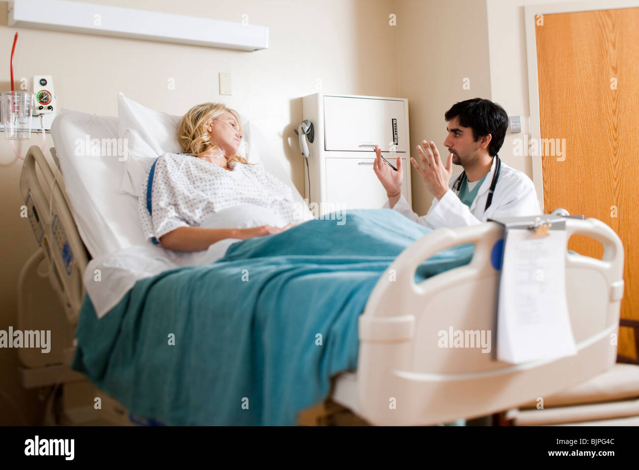 Woman in hospital bed Stock Photo