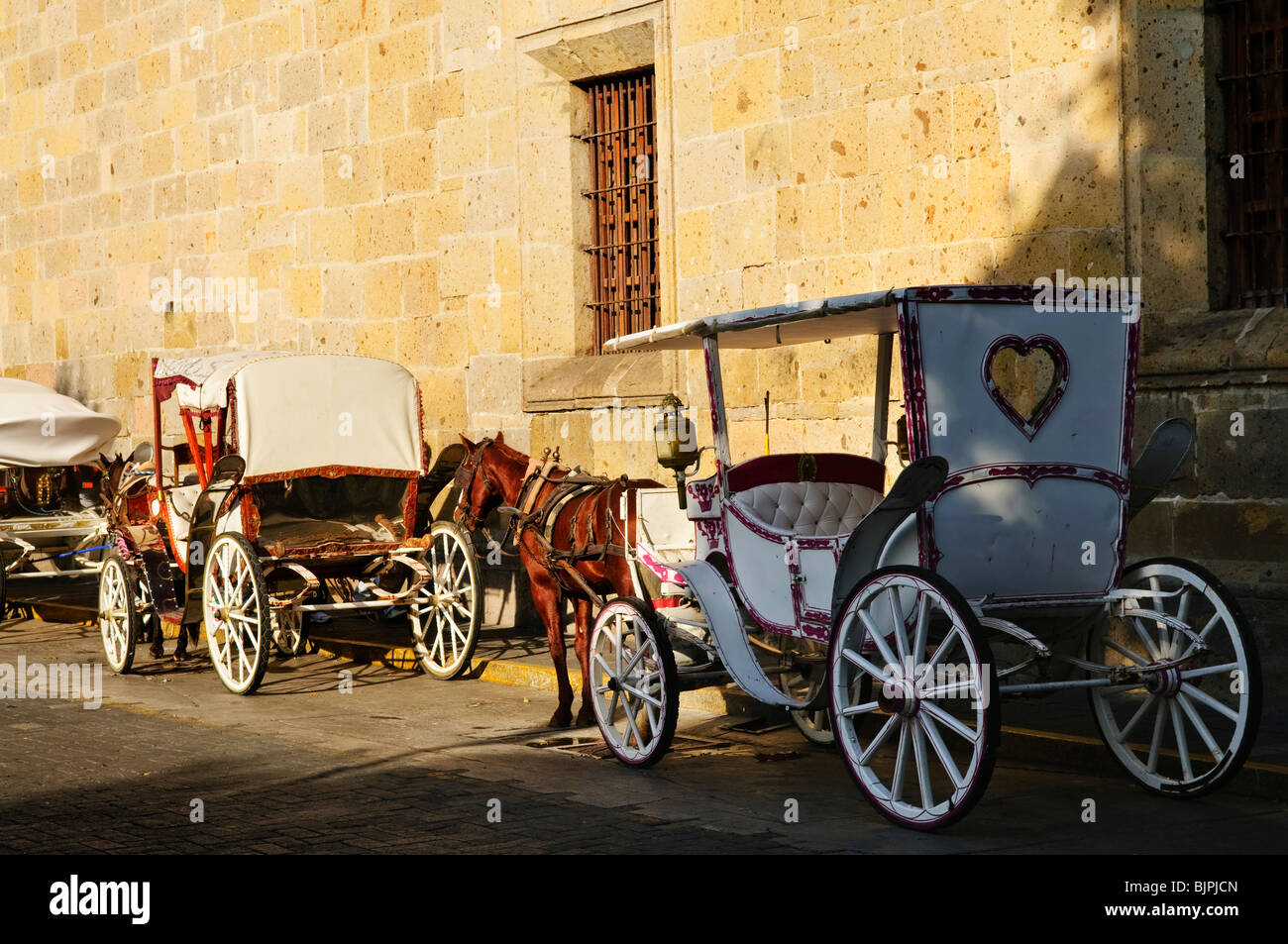 Horse drawn carriages waiting for tourists in historic Guadalajara, Jalisco, Mexico Stock Photo