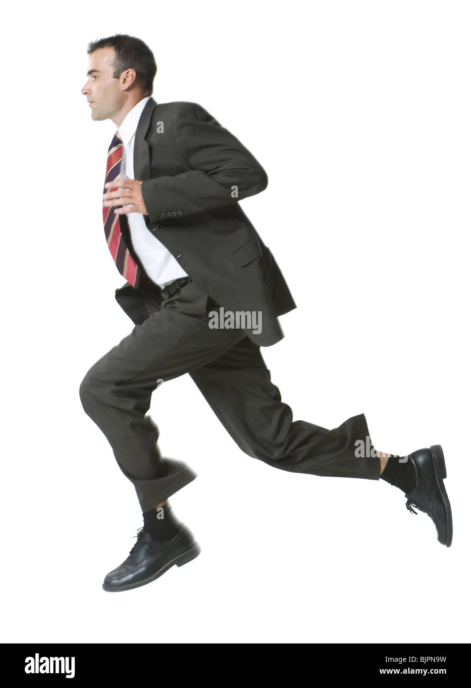 Man running in three piece suit Stock Photo - Alamy