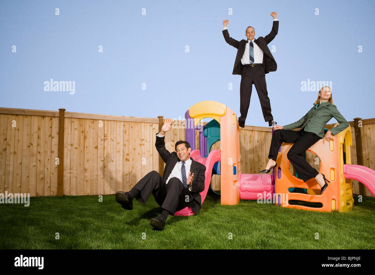 Business people on play structure Stock Photo