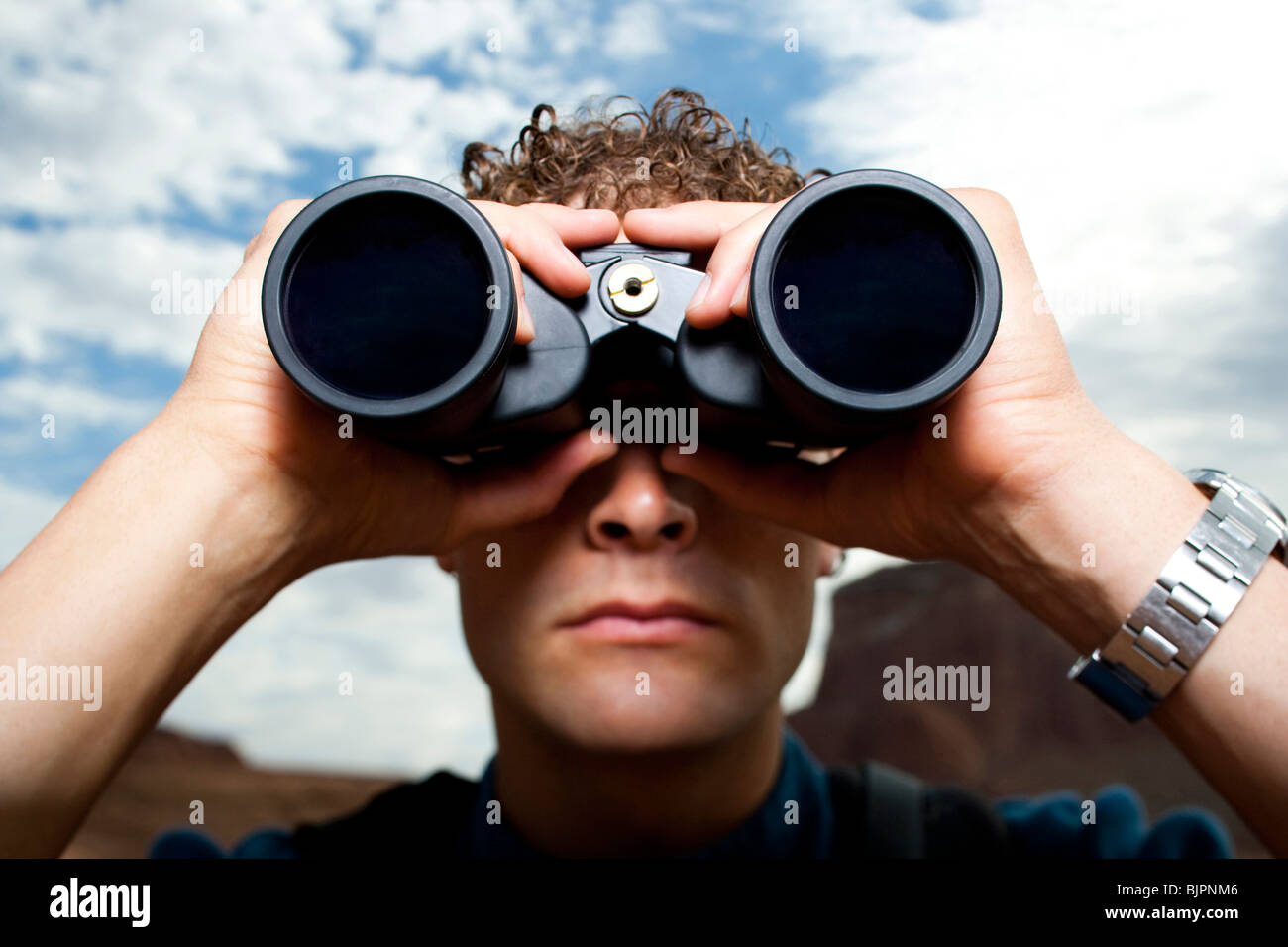 Close-up of man with binoculars Stock Photo