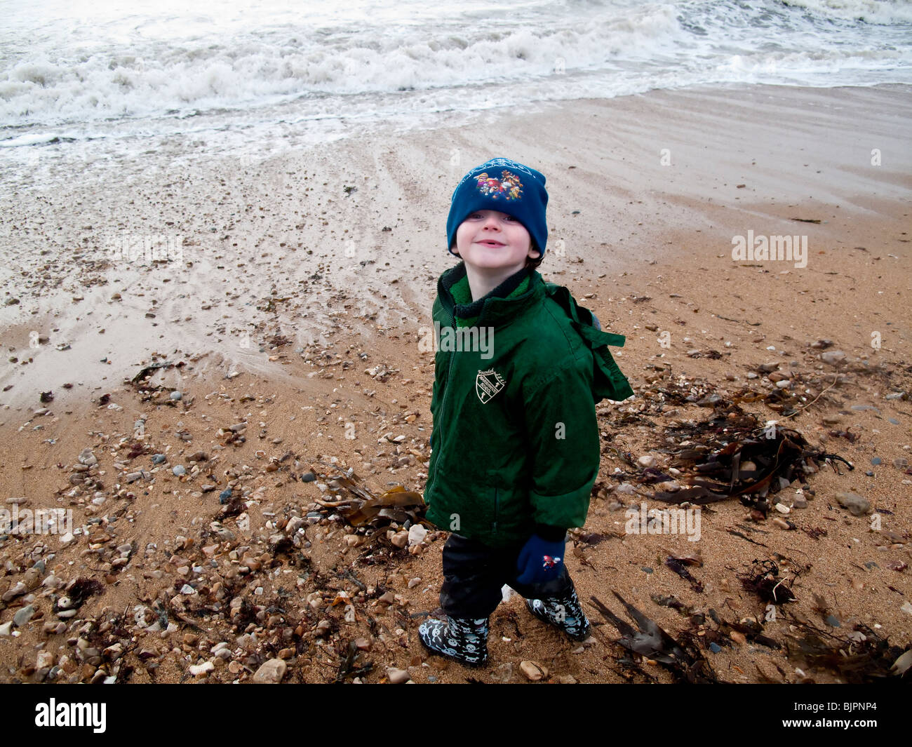 Six year old boy on Charmouth Beach. Dorset, England, UK Stock Photo