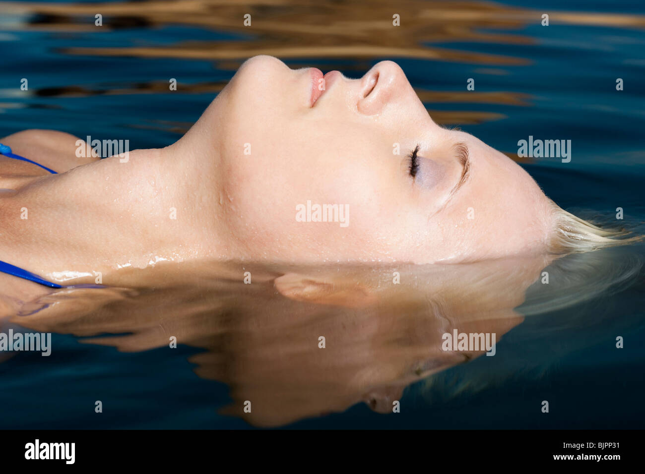 Close-Up of woman resting in water Stock Photo - Alamy