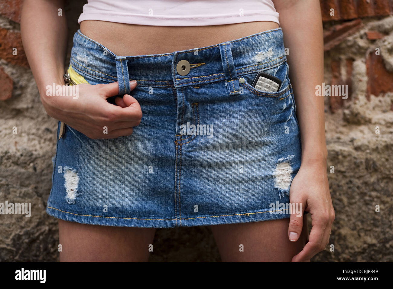 Midsection of a woman in short skirt Stock Photo