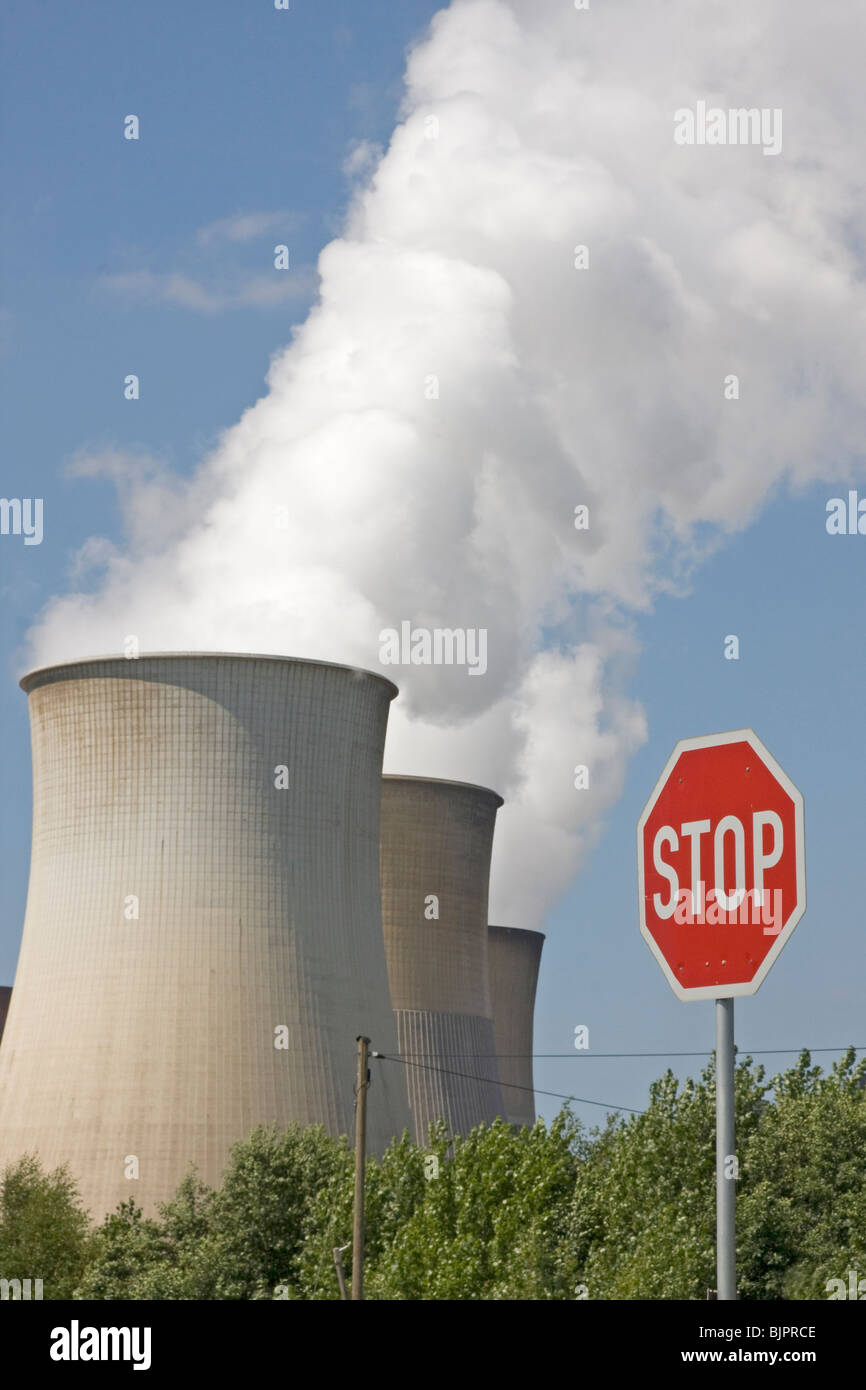 smoky cooling tower with a stop sign Stock Photo