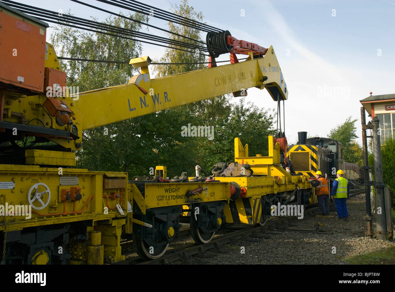 Cowans Sheldon 50 tonne strut jib rail crane at Crewe, Cheshire, UK.  Stowing the jib on to the relieving bogey. Stock Photo