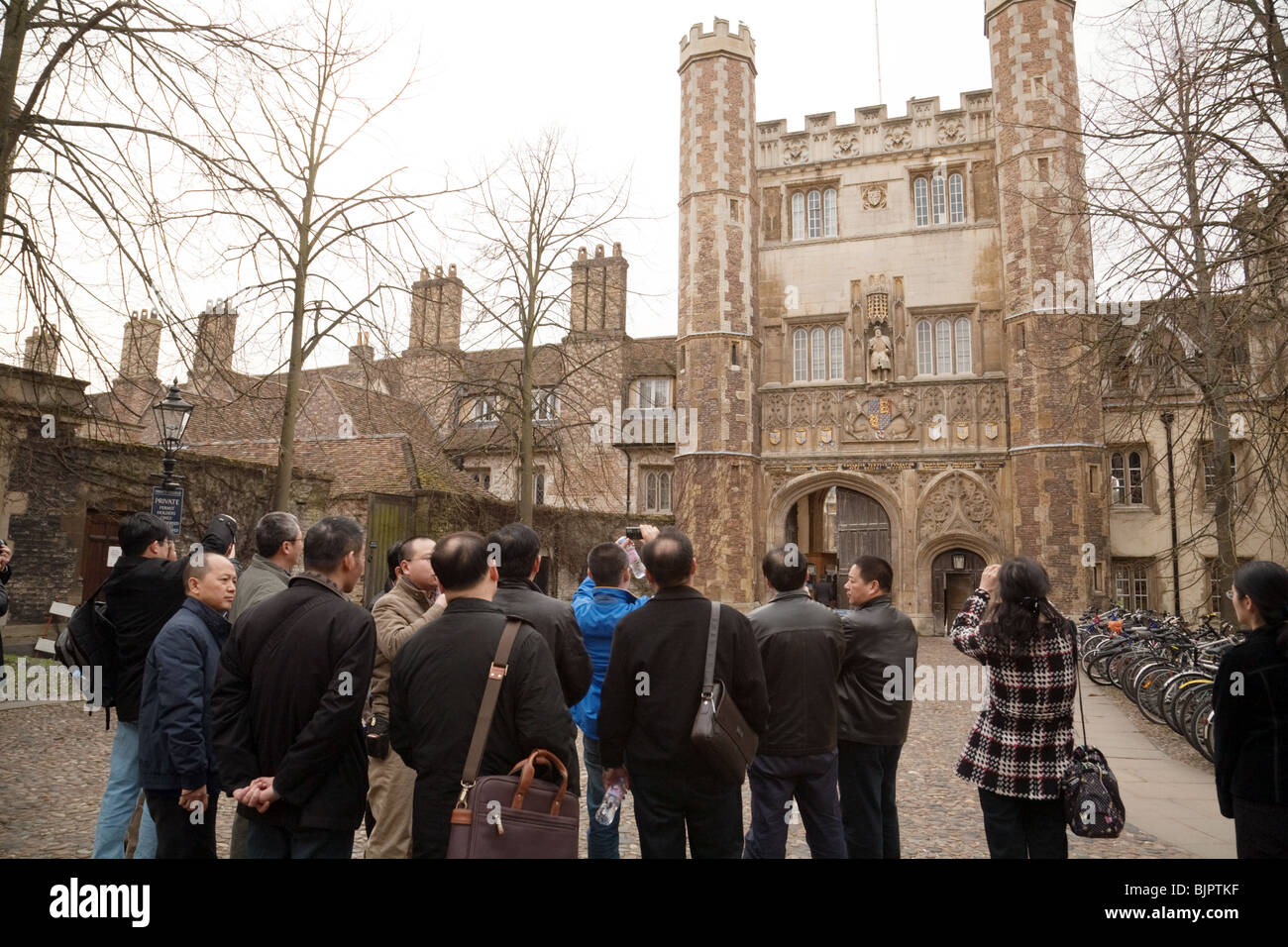 Tourists at the main entrance to Trinity College, on Trinity Street, Cambridge University, UK Stock Photo