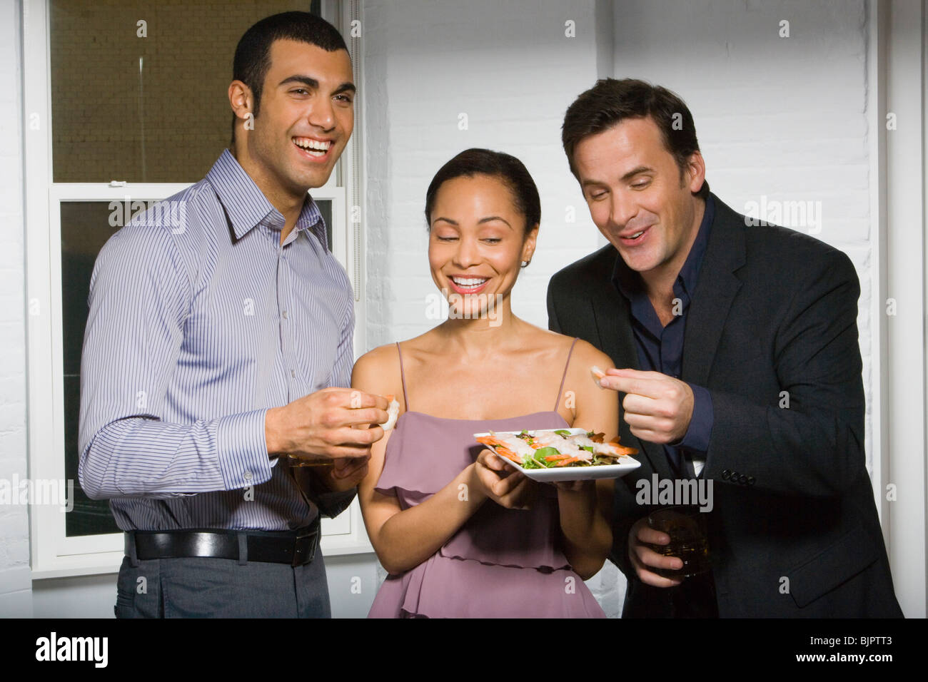 Partygoers eating Stock Photo