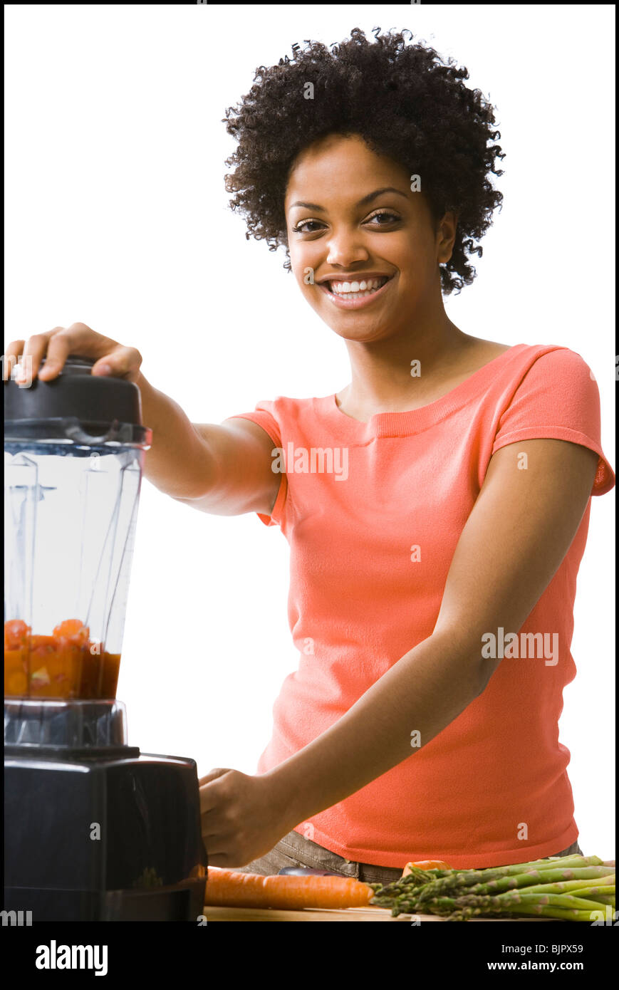 Woman using a blender Stock Photo