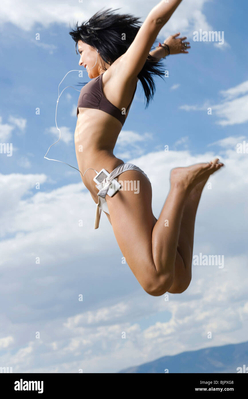 Woman in bikini jumping Stock Photo Alamy