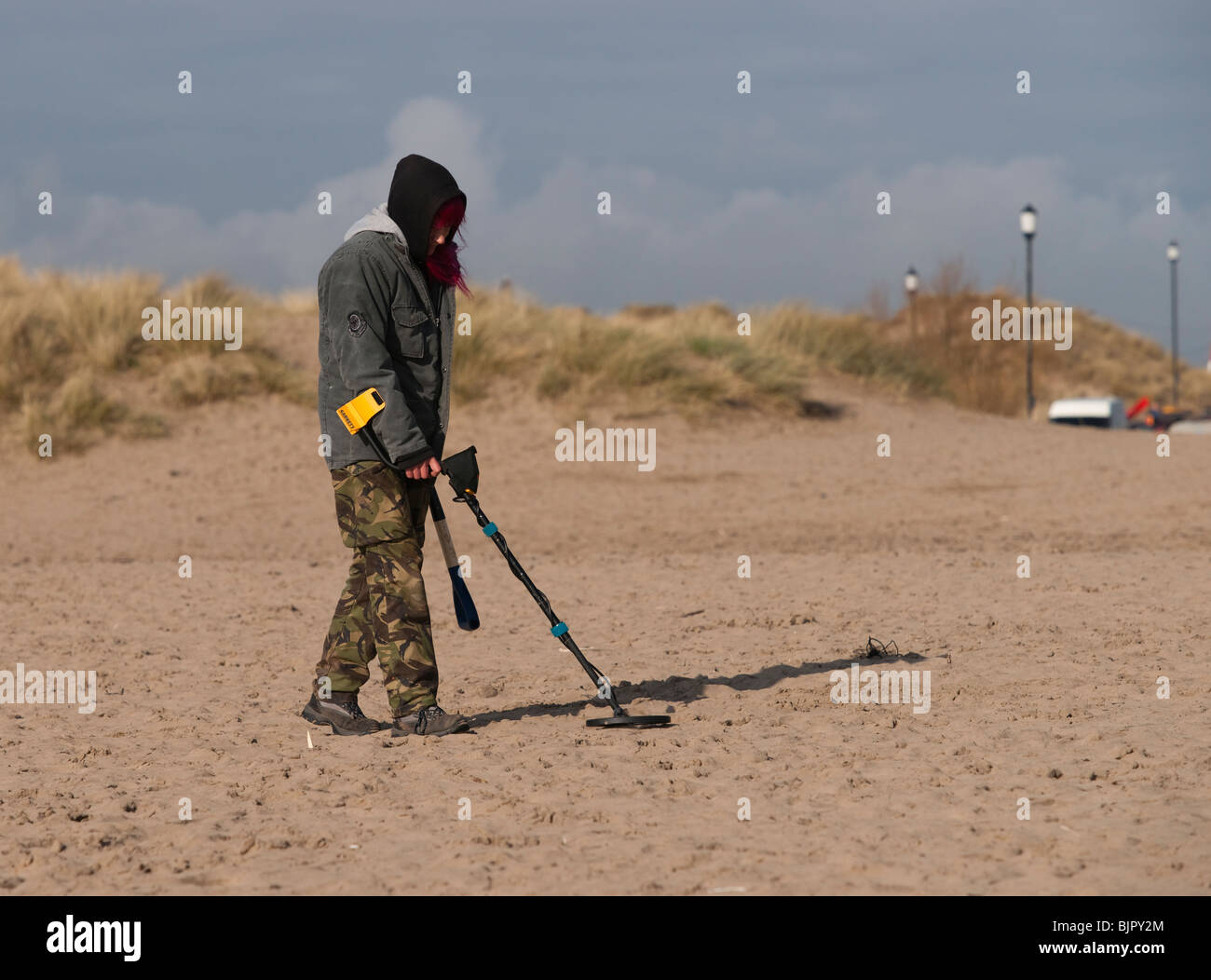 A woman Metal detecting on the beach at Instow. North Devon. UK Stock