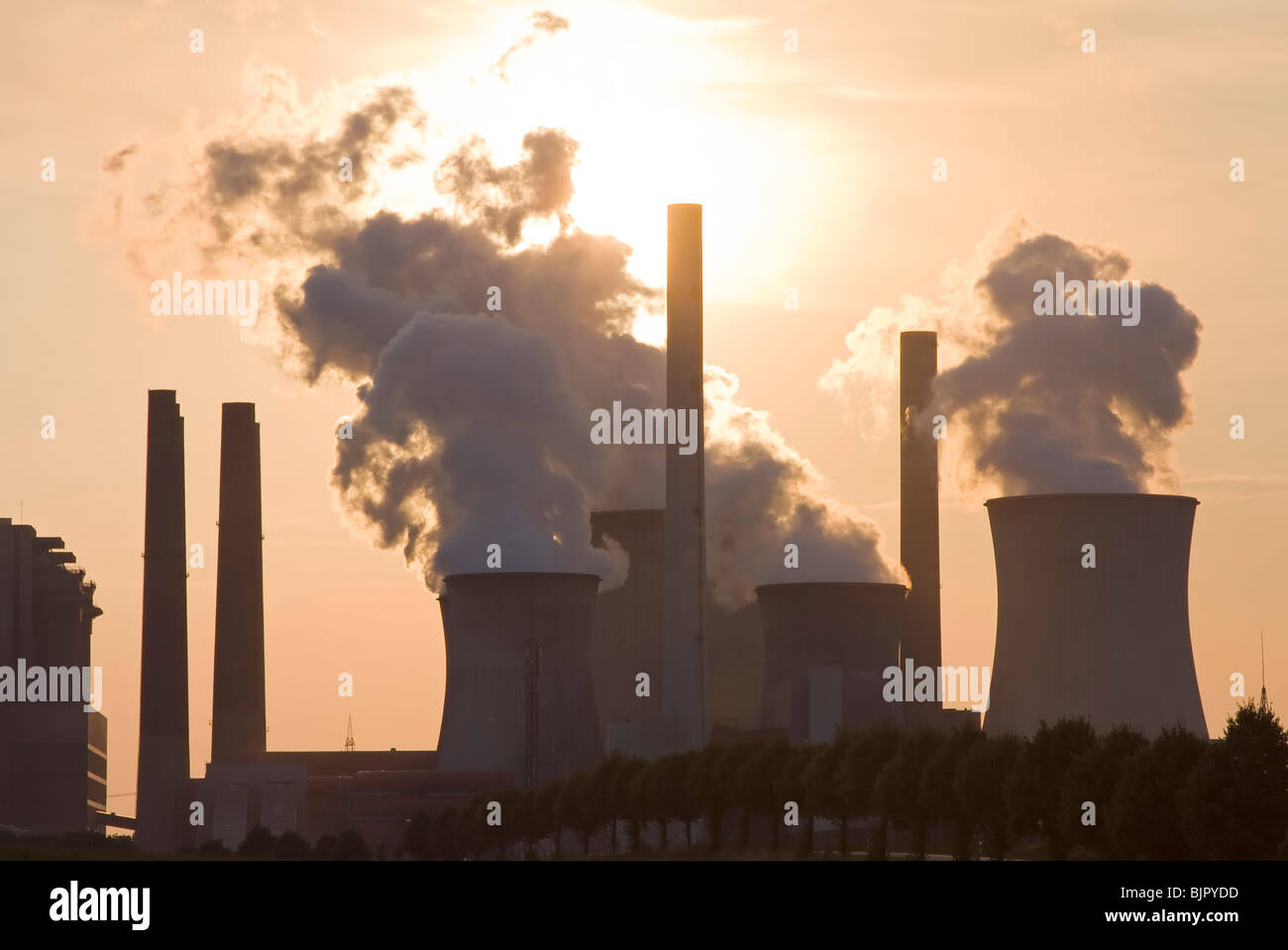 smoky cooling tower in a sundown Stock Photo