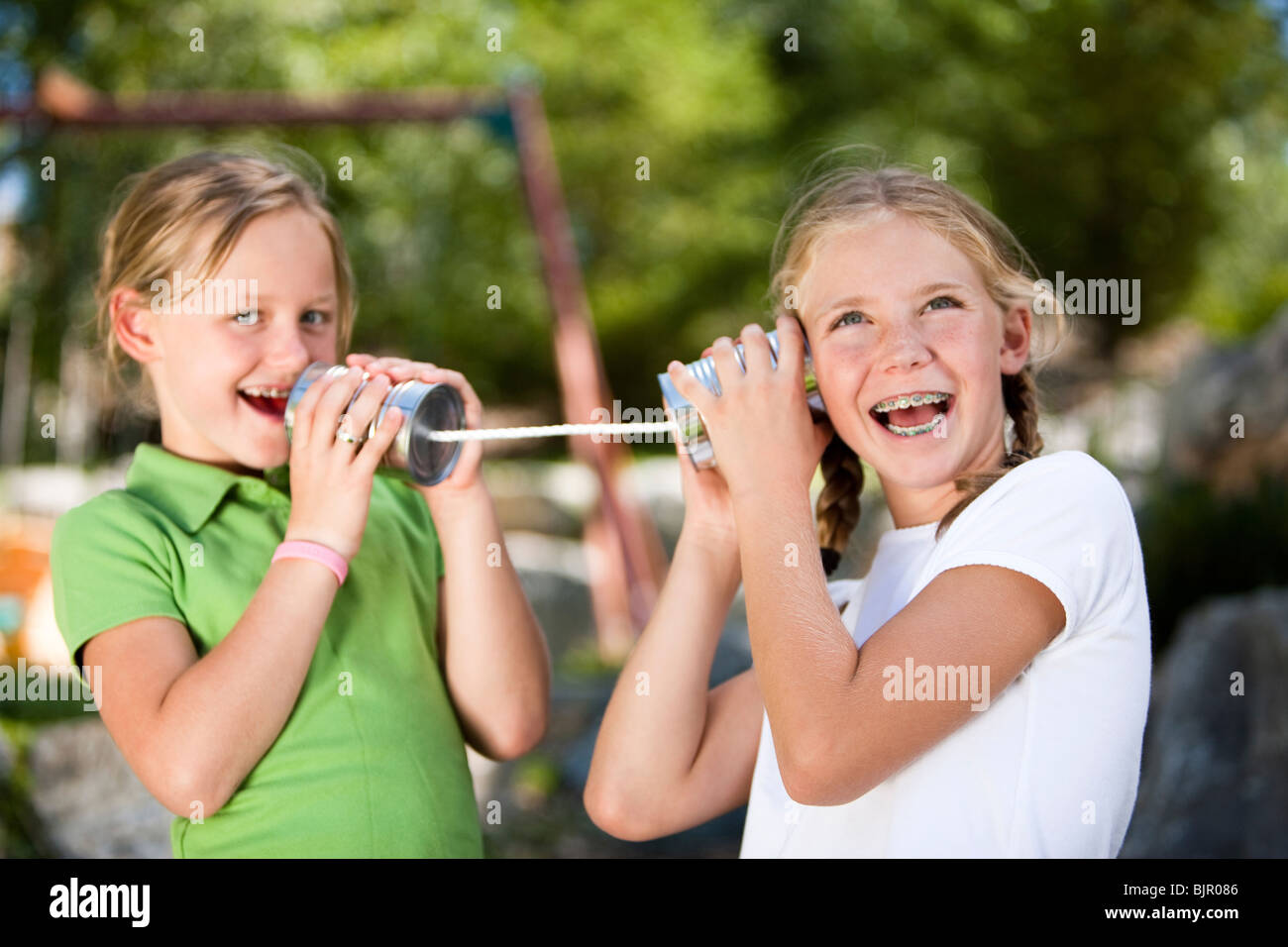 Girl on tin can phone Stock Photo