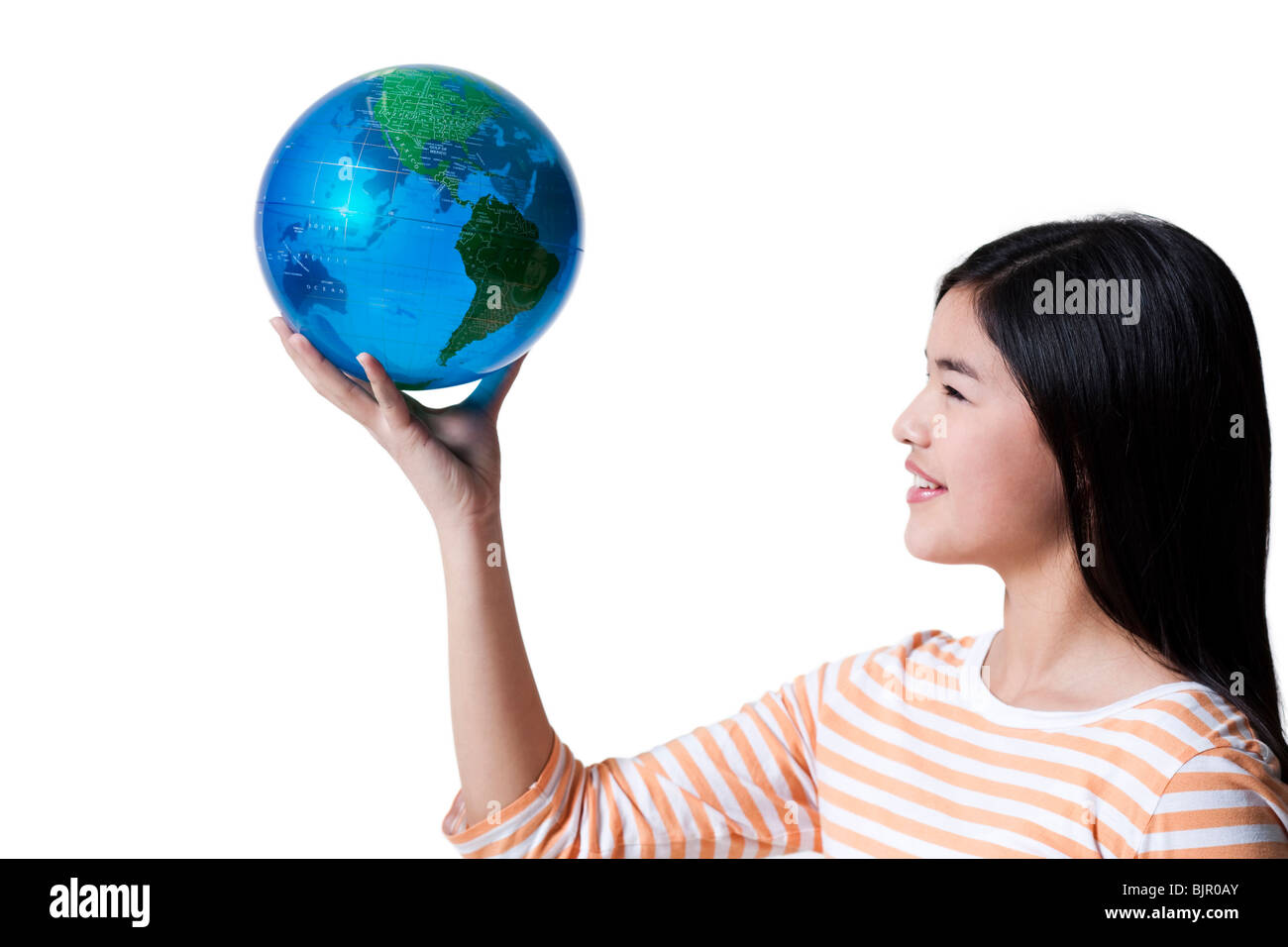 Teenage girl standing with a globe Stock Photo