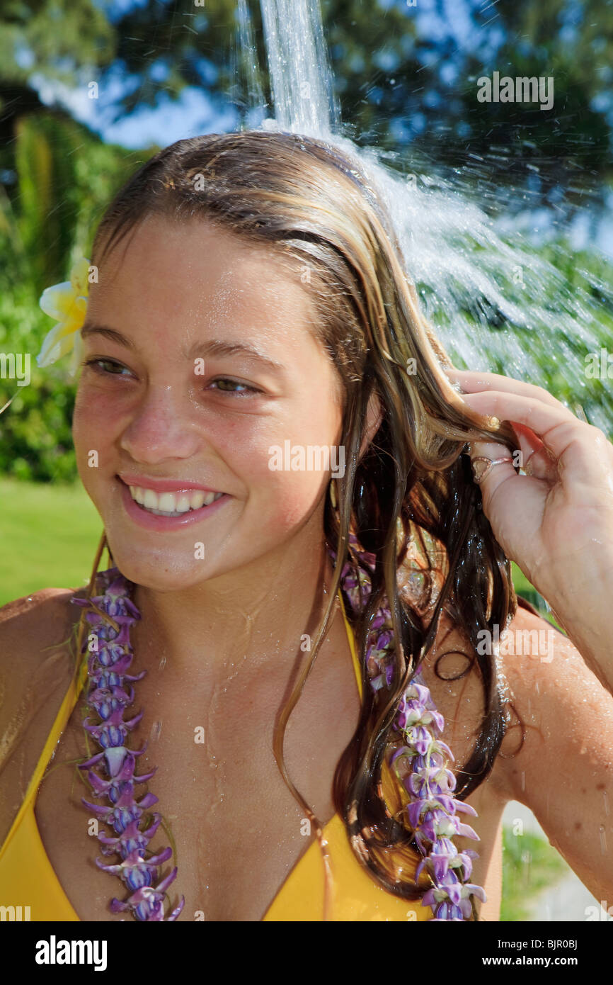 beautiful teenager in yellow bikini taking a shower outdoors Stock Photo -  Alamy