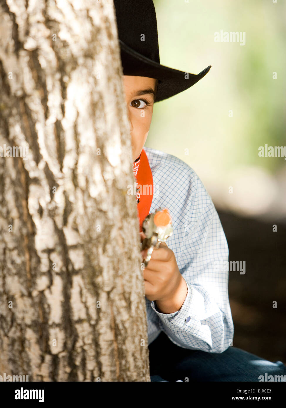 Boy in cowboy costume with toy gun Stock Photo Alamy