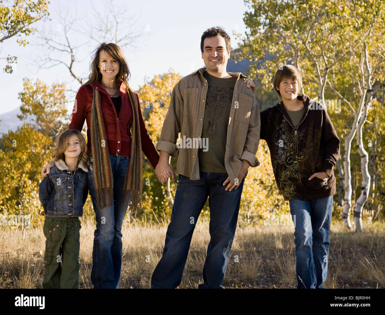 Family of four, outdoors. Stock Photo