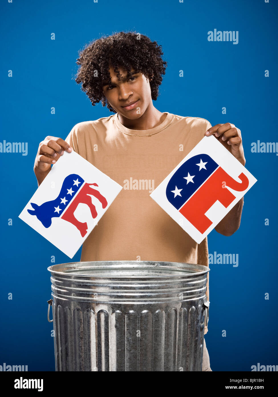 young man in a brown shirt throwing away a political party symbol. Stock Photo