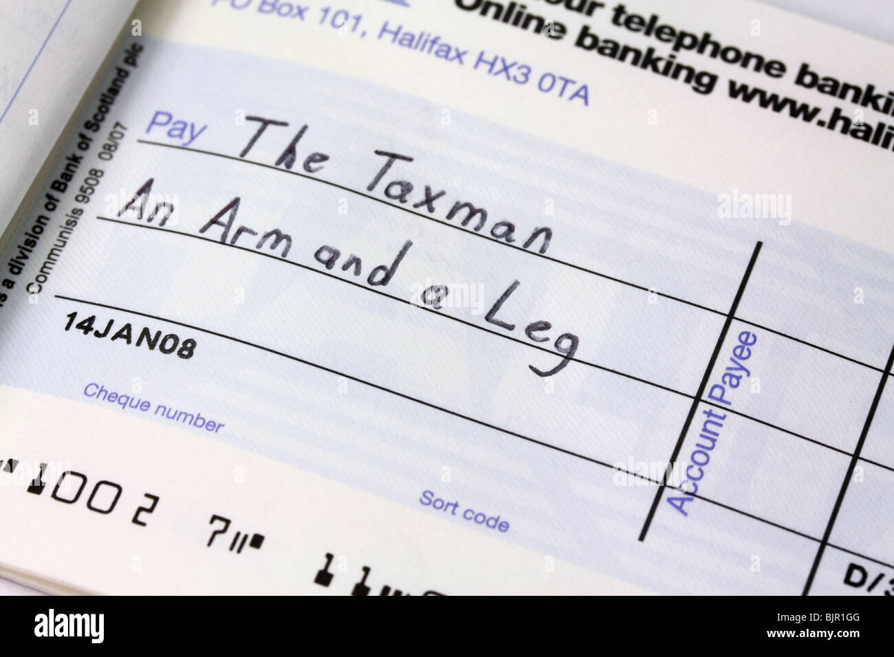 Writing a cheque to the Taxman Stock Photo